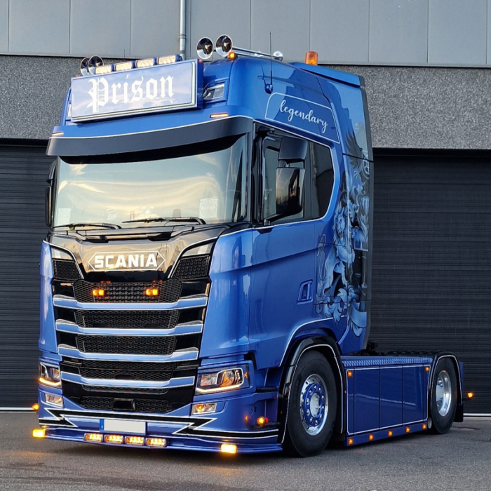 Scania Next Gen vrachtwagen met oranje glas dubbelbrander op de grille
